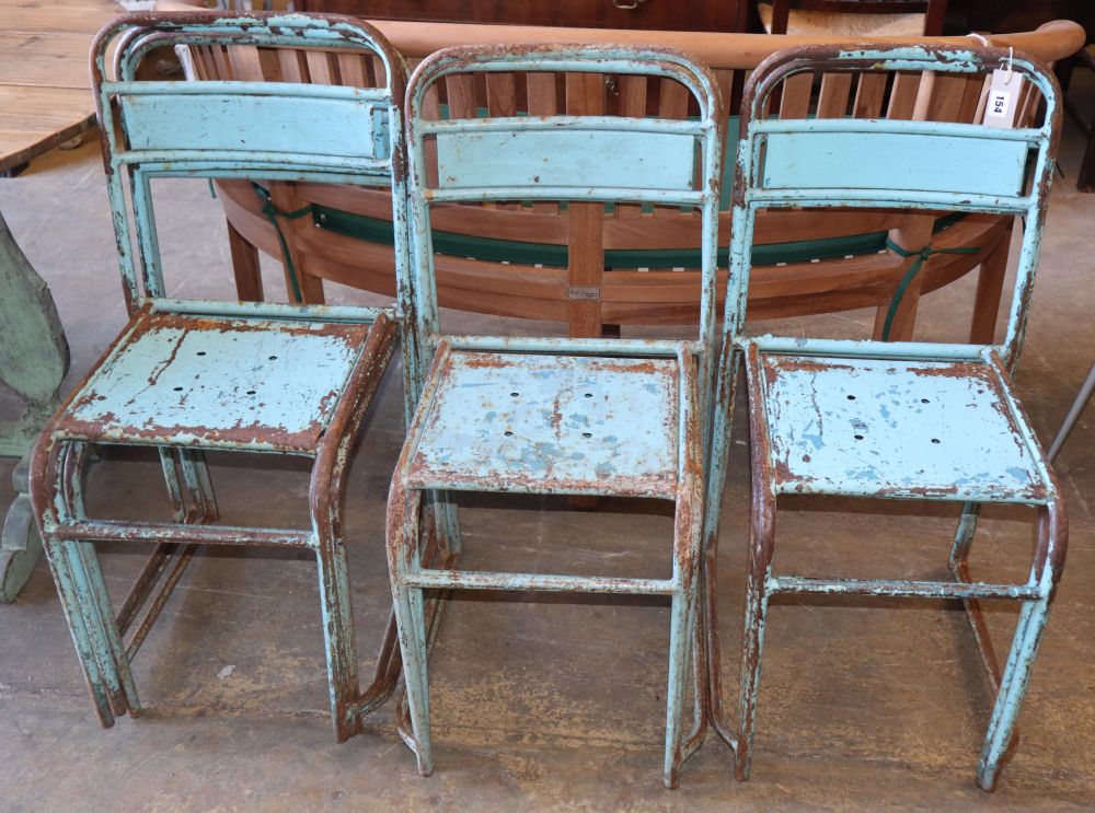 A set of seven vintage painted metal stacking chairs
